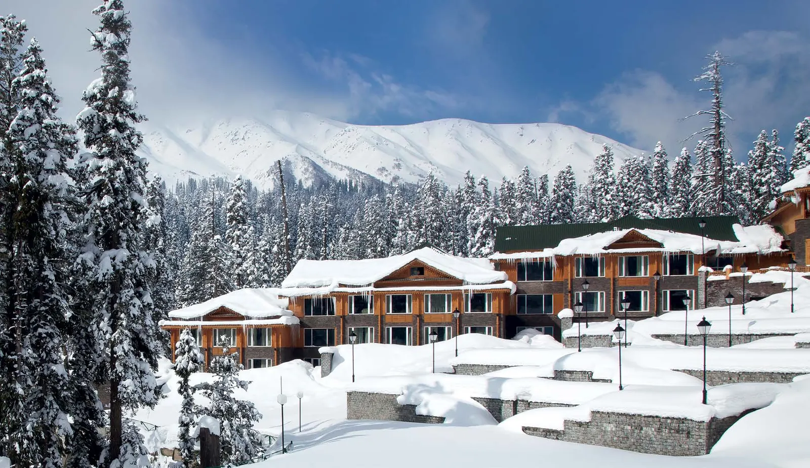Snow-covered Gulmarg resort under a clear blue sky