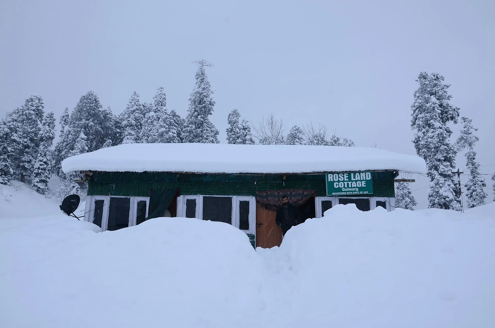 Cottage buried in fresh Gulmarg powder snow — winter ski package