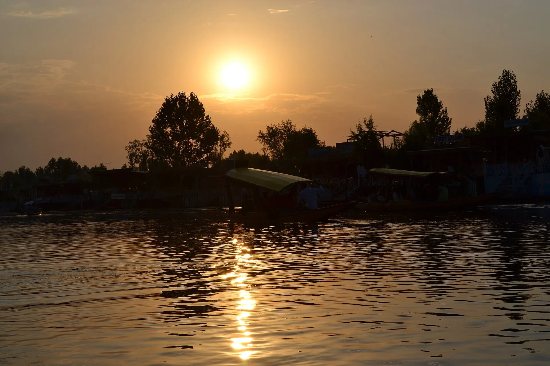 A shikara resting on still Dal Lake water